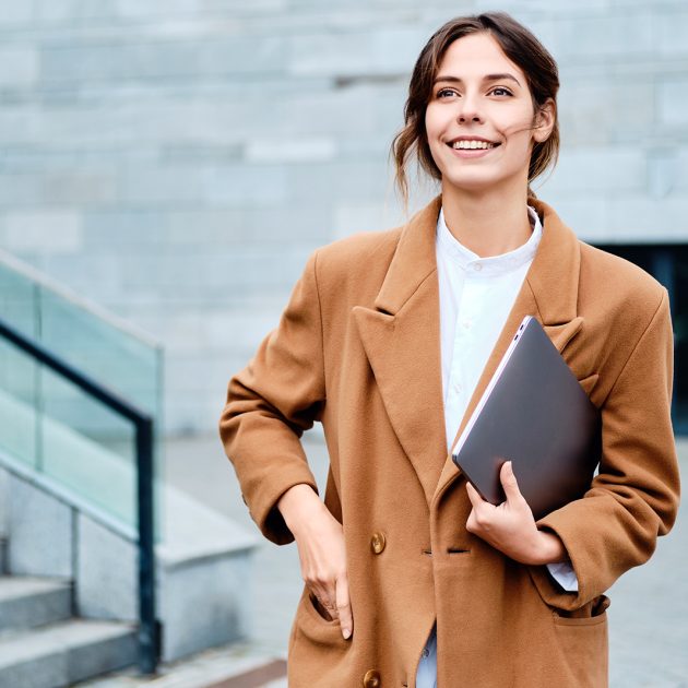 young-pretty-smiling-businesswoman-in-coat-with-2J3SG5G